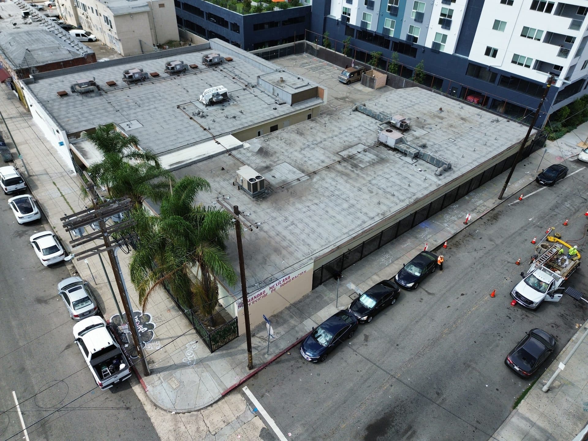Corner aerial — 2501 S Hill St roof, parcel, and USC / Downtown-South context